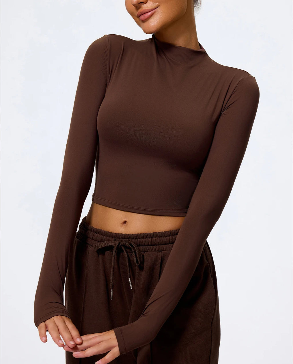 Brown long-sleeve top and skirt set on a white background
