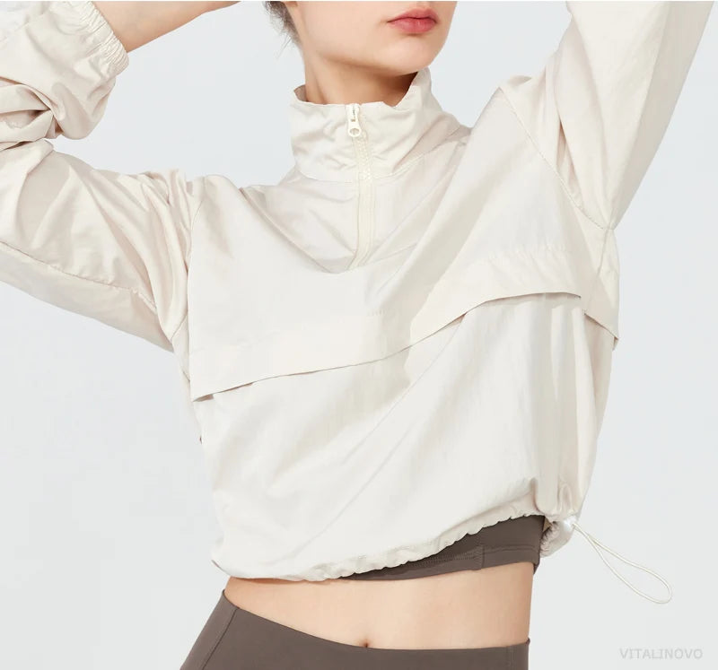 Person wearing a beige puffer jacket on a white background