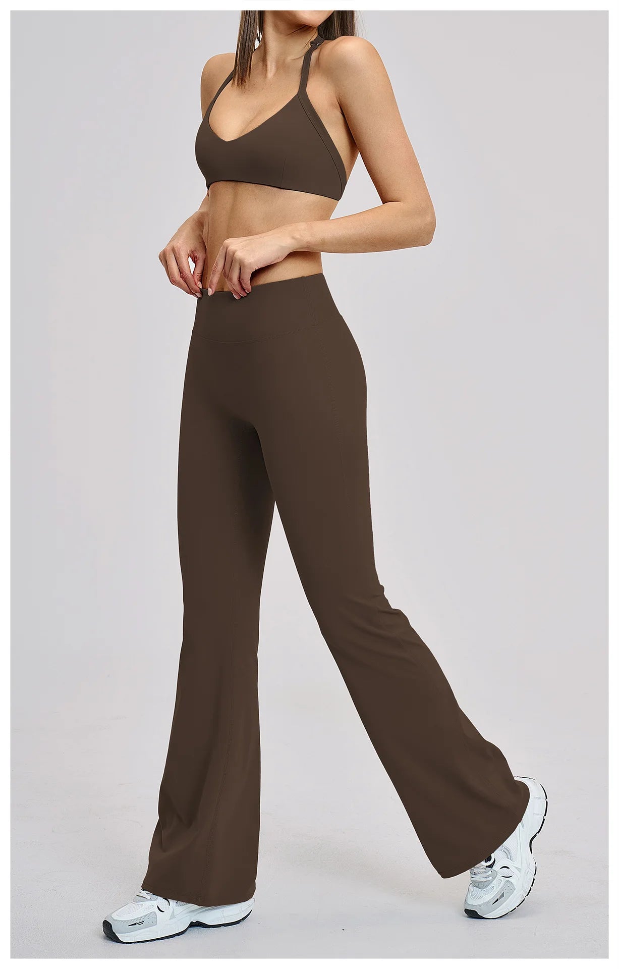 Person wearing a brown sports bra and leggings set on a light gray background