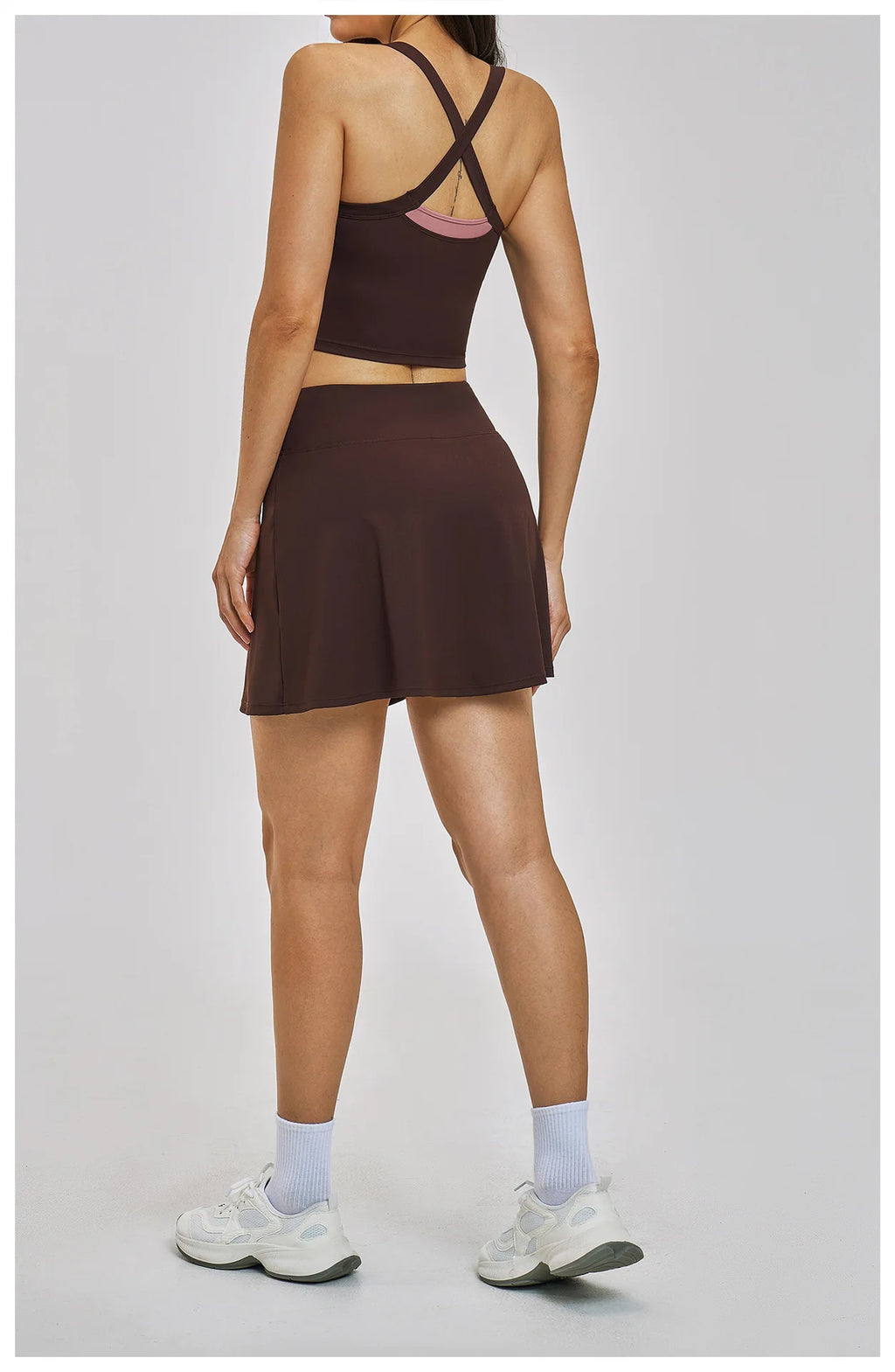 Person wearing a brown athletic outfit on a plain background