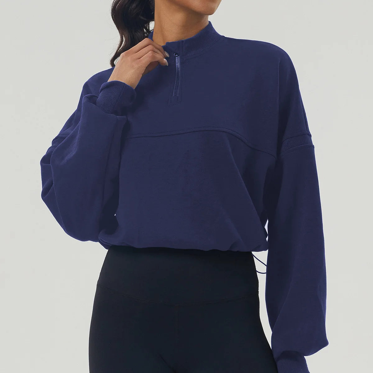 Navy blue pullover worn by a person on a light gray background