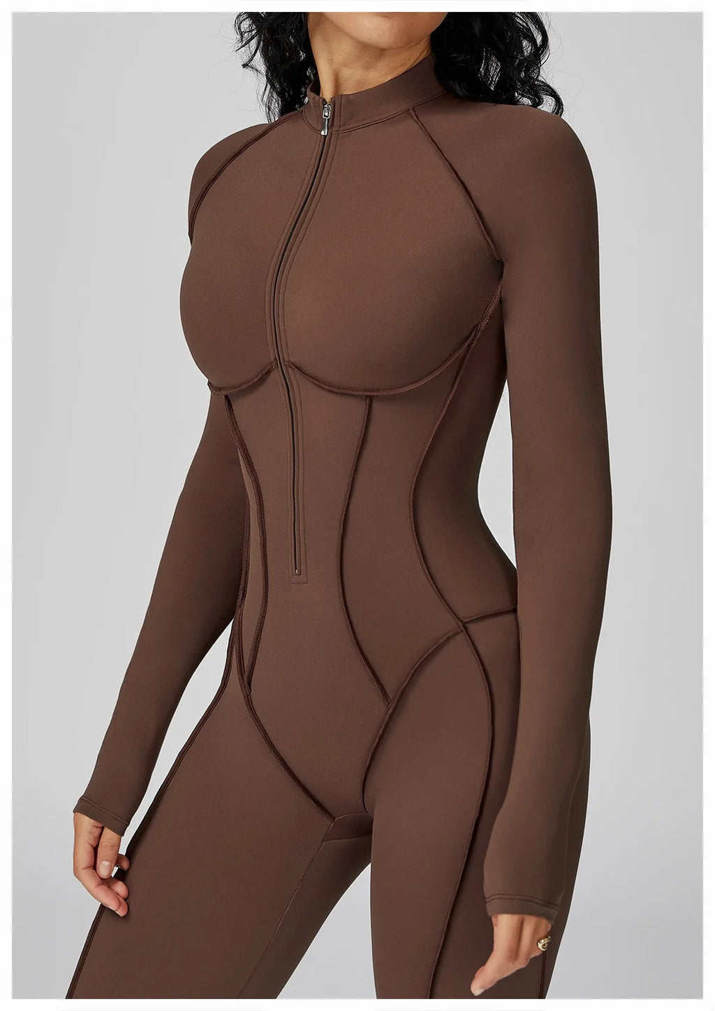 Brown bodysuit worn by a model on a plain background