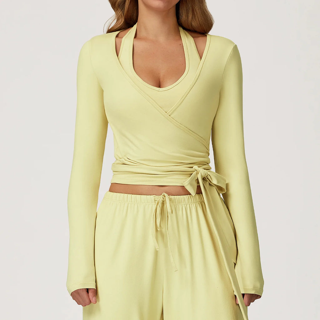 Light yellow long-sleeve ballet wrap top and pants set on a plain background