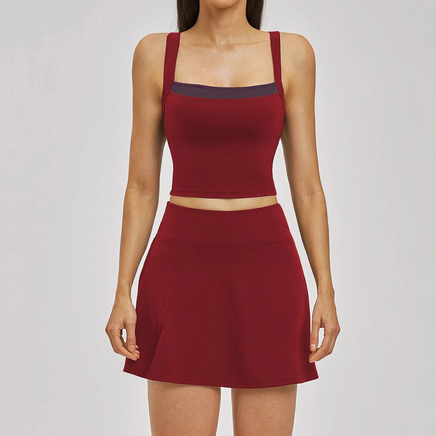 Red two-piece outfit with a top and skirt on a plain background
