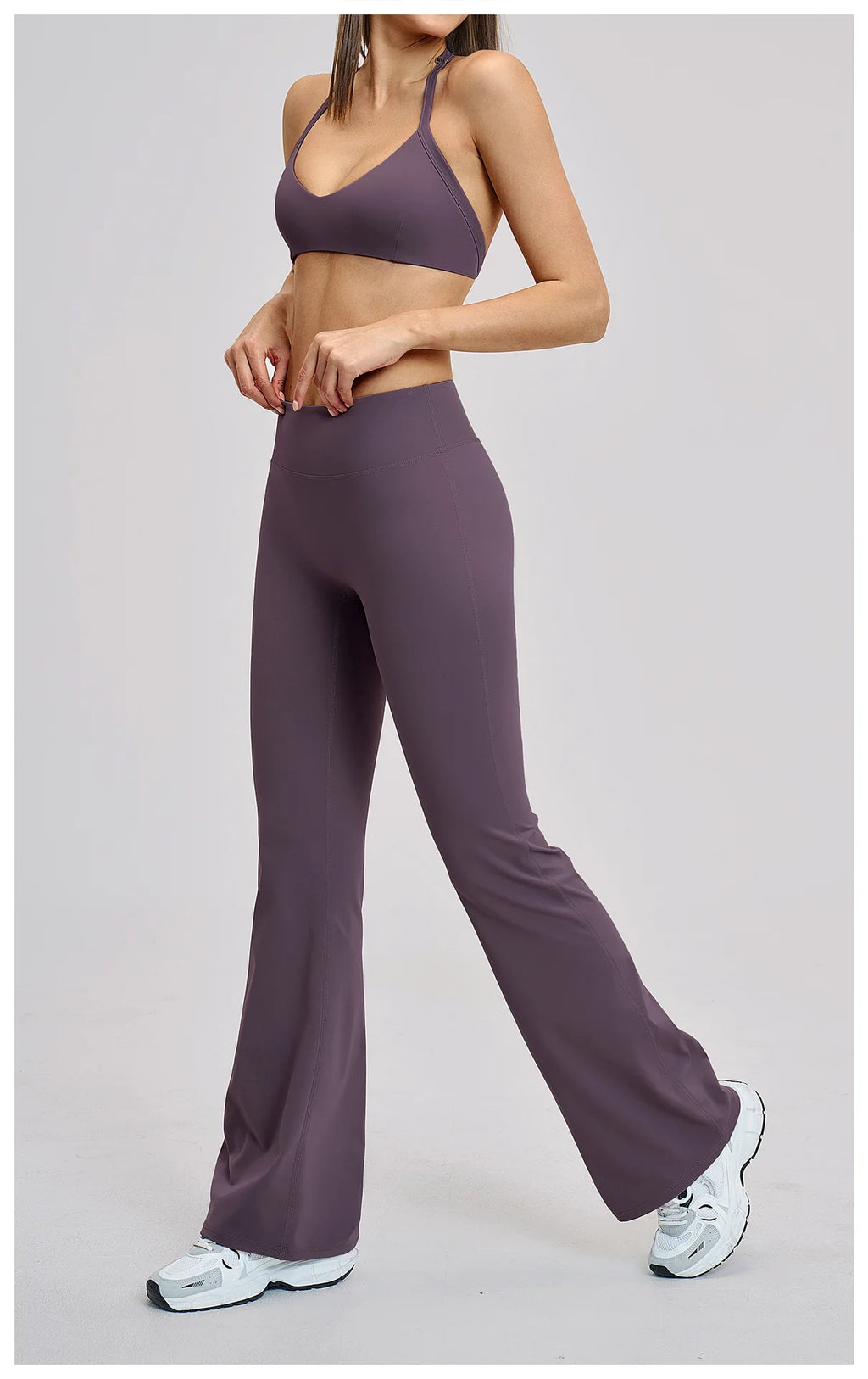 Person wearing a purple athletic outfit on a plain background