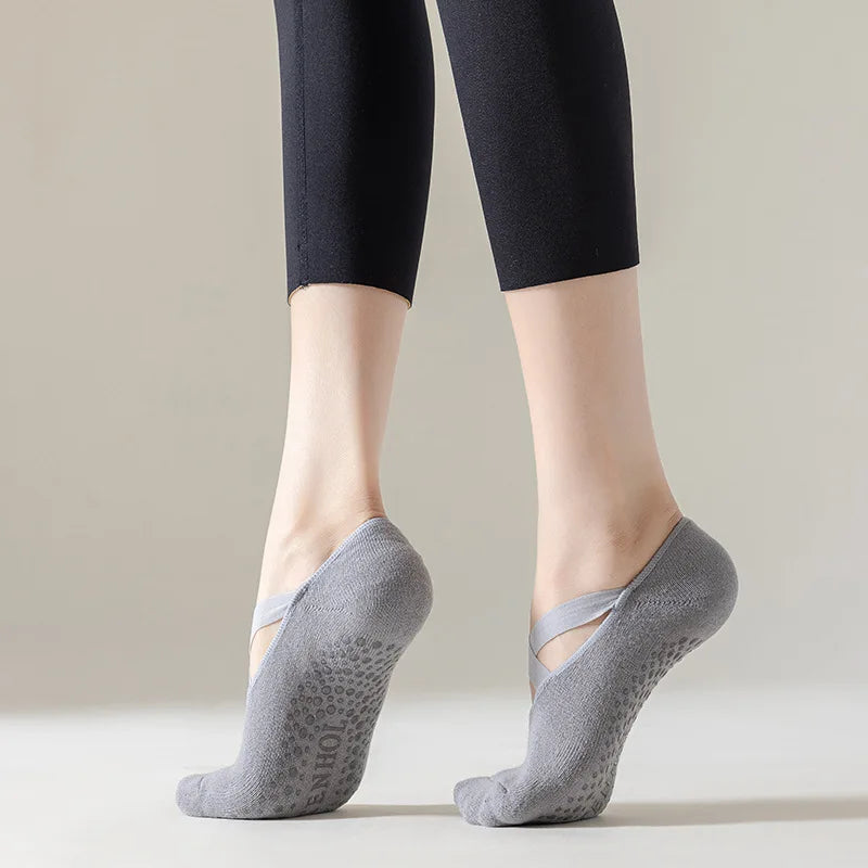 Person wearing gray socks with a subtle pattern on a plain background