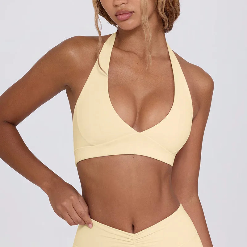 Woman wearing a yellow bikini set against a plain background