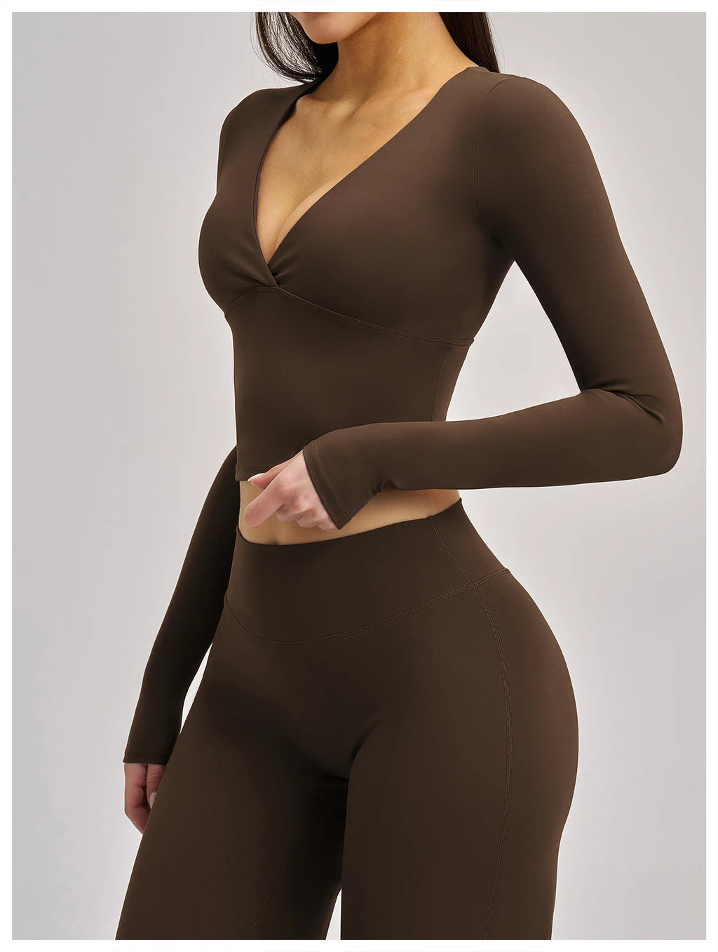 Brown long-sleeve top and leggings set on a plain background