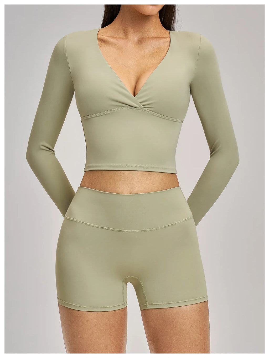 Olive green athletic top and shorts set on a plain background