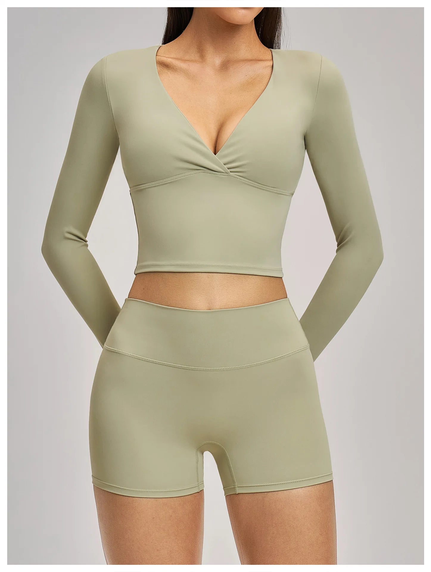 Olive green athletic top and shorts set on a plain background