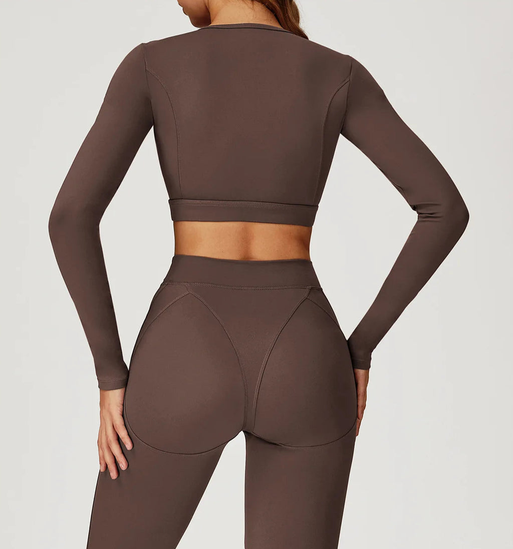 Brown long-sleeve athletic top and leggings on a plain background