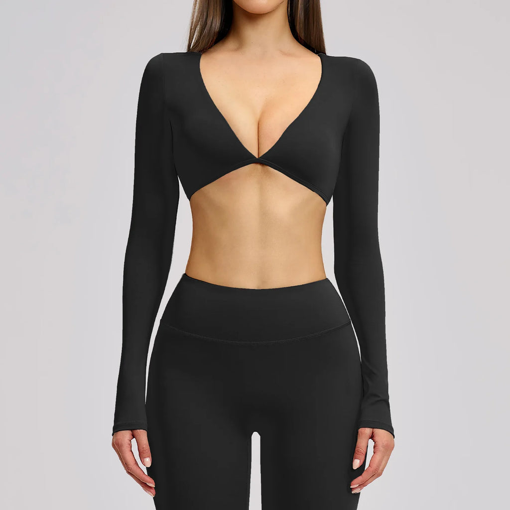 Black long-sleeve top with cut-out design on a gray background