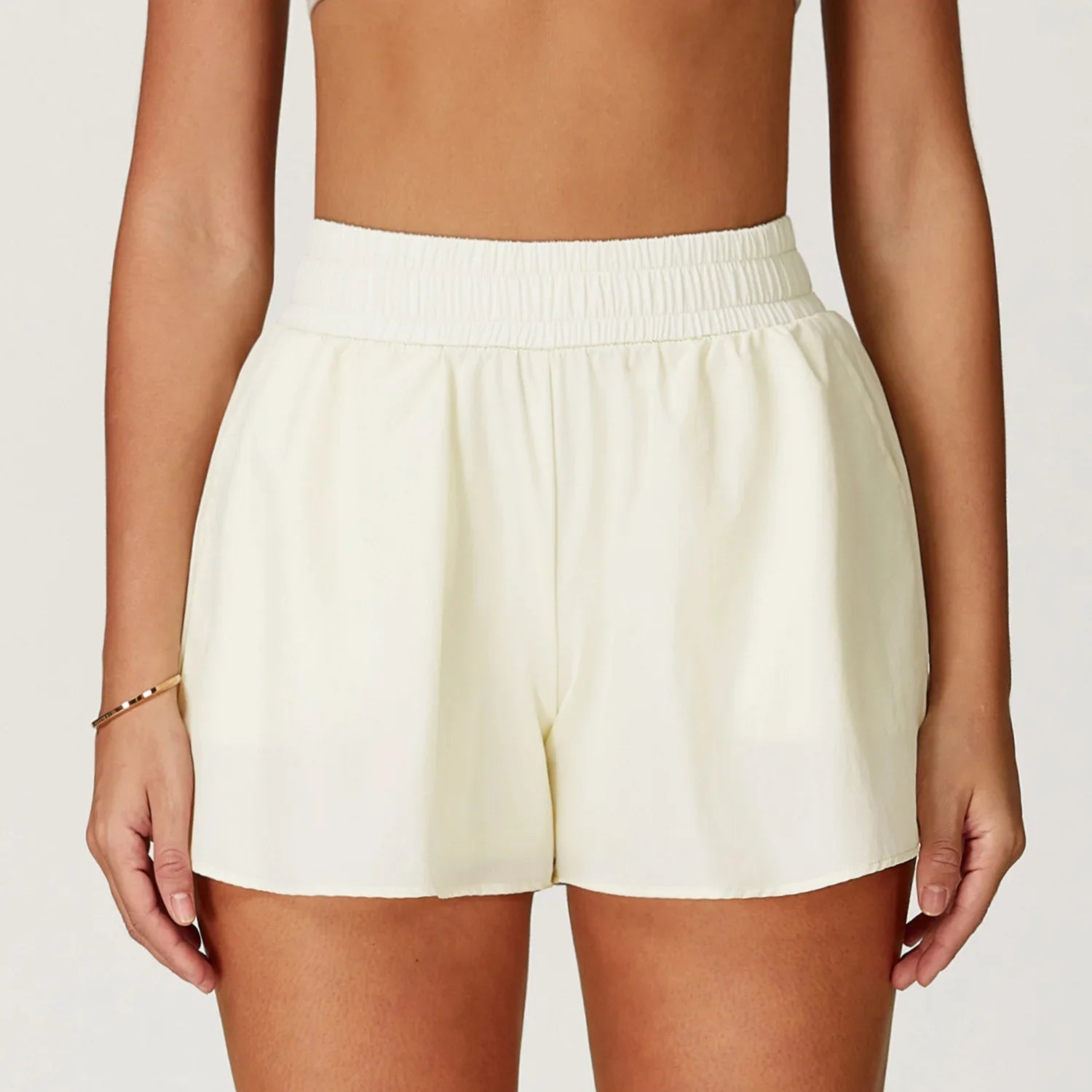 White shorts worn by a person on a plain background