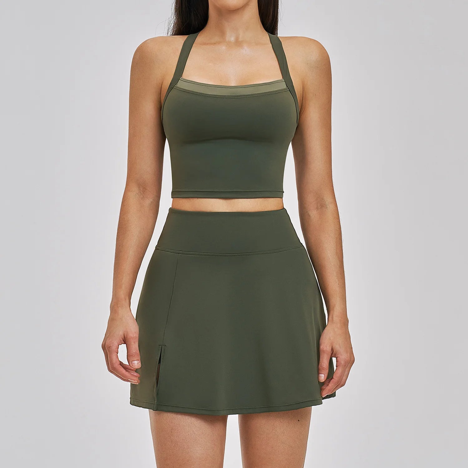 Person wearing a green athletic outfit on a plain background