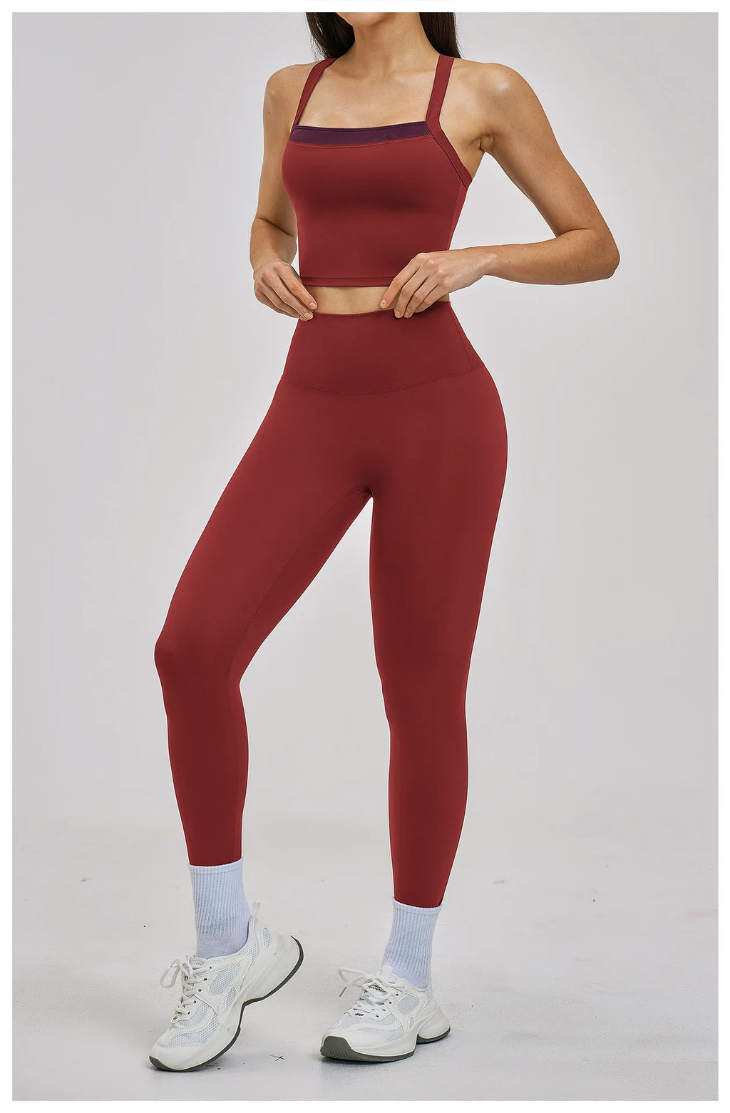 Person wearing a maroon athletic outfit on a white background