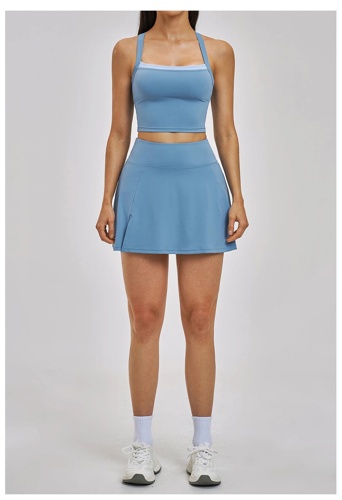 Person wearing a blue athletic outfit on a light gray background