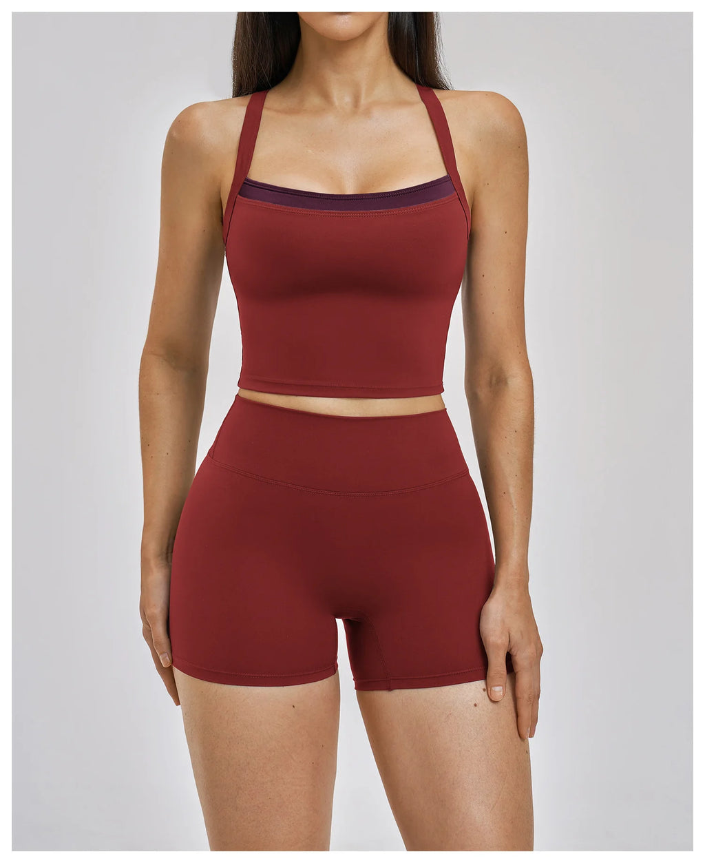 Maroon sports bra and shorts set on a plain background