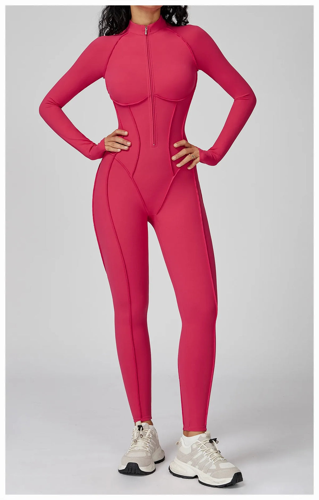 Person wearing a bright pink bodysuit on a light gray background