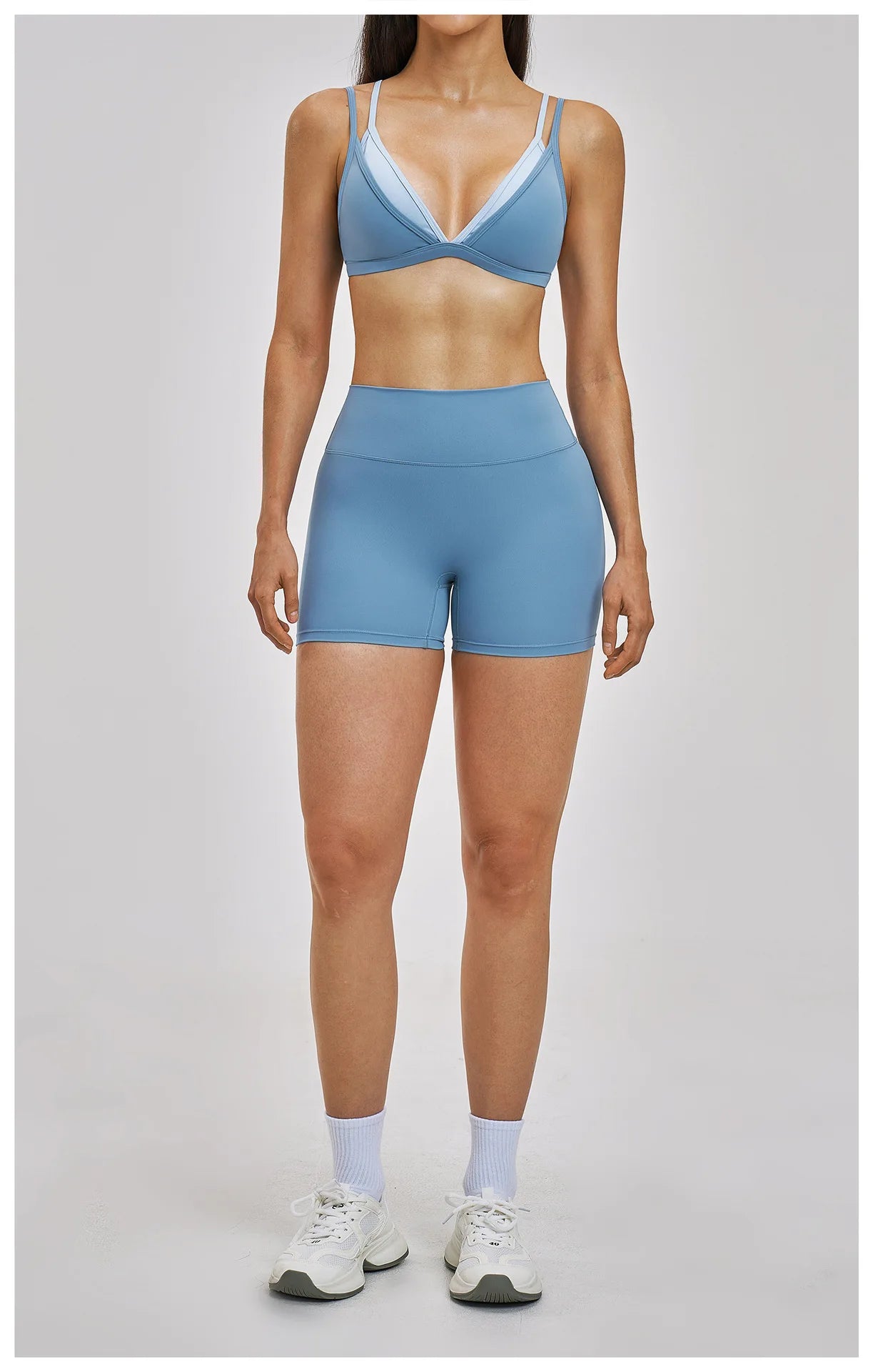 Person wearing a blue athletic outfit on a gray background