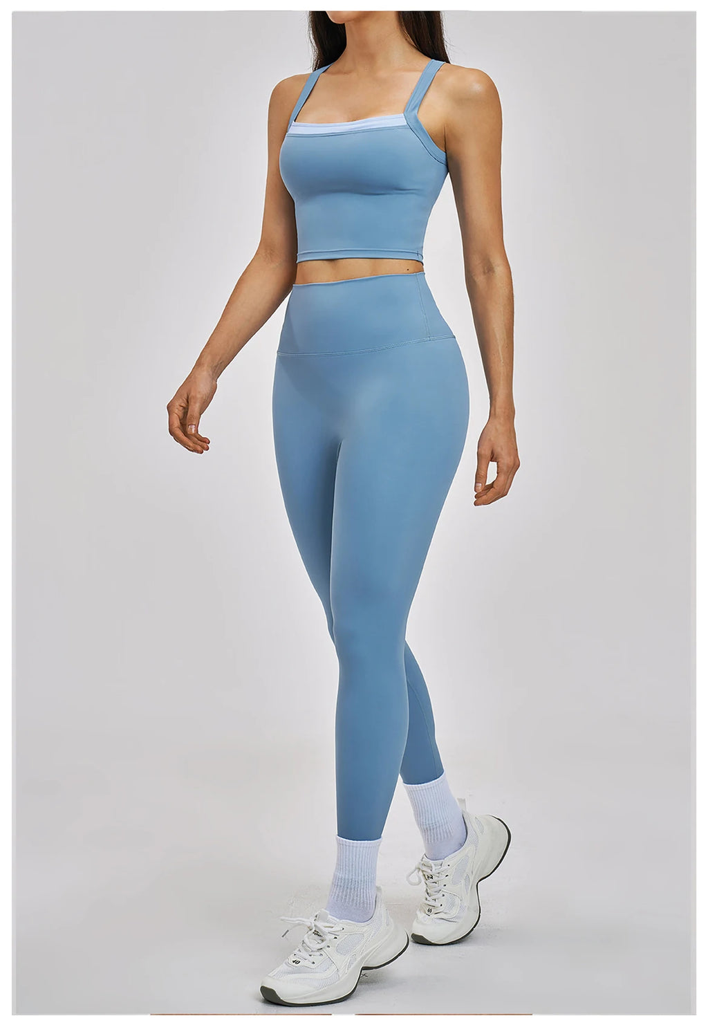 Woman wearing a blue athletic outfit on a white background