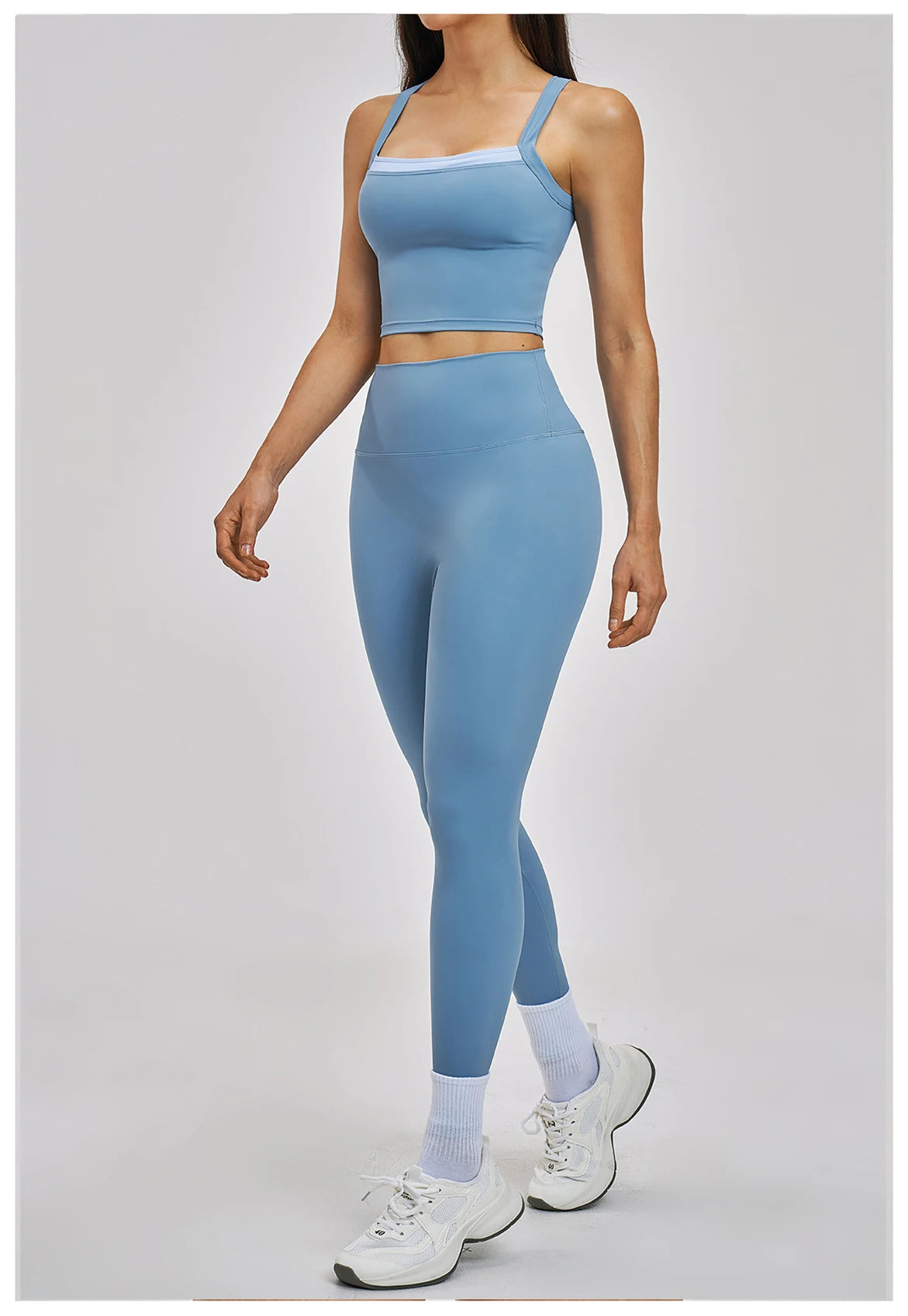 Woman wearing a blue athletic outfit on a white background