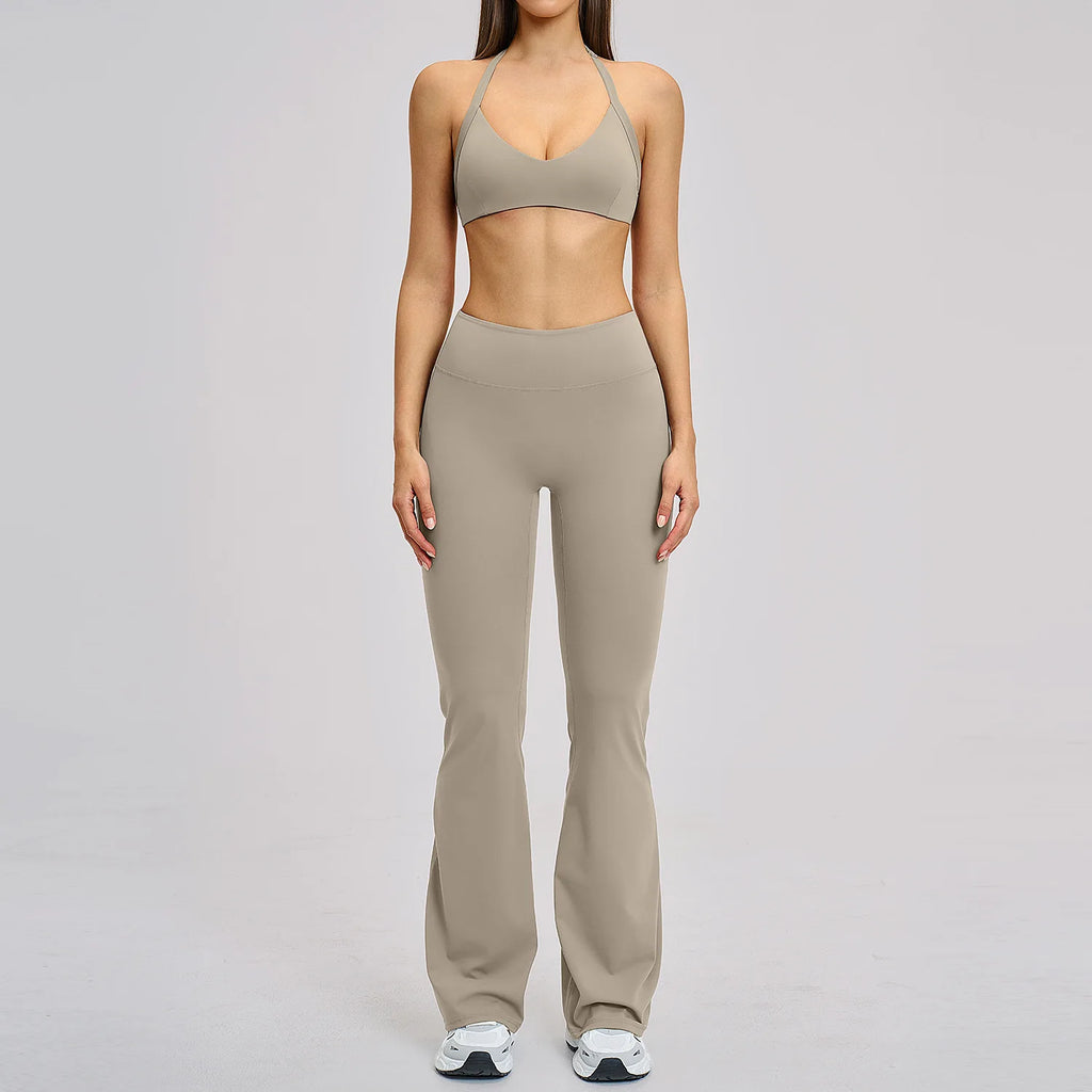 Person wearing a beige sports bra and leggings set on a gray background