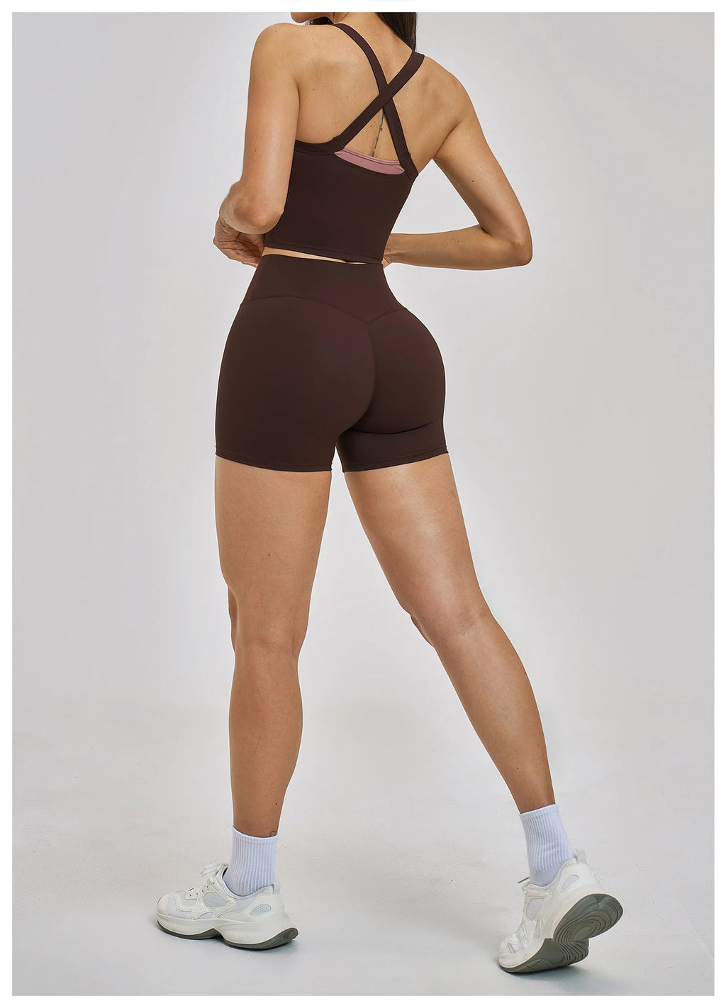 Person wearing a brown athletic outfit on a white background