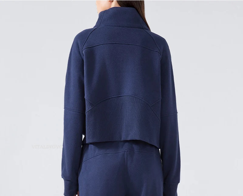 Navy blue jacket worn by a person on a light gray background