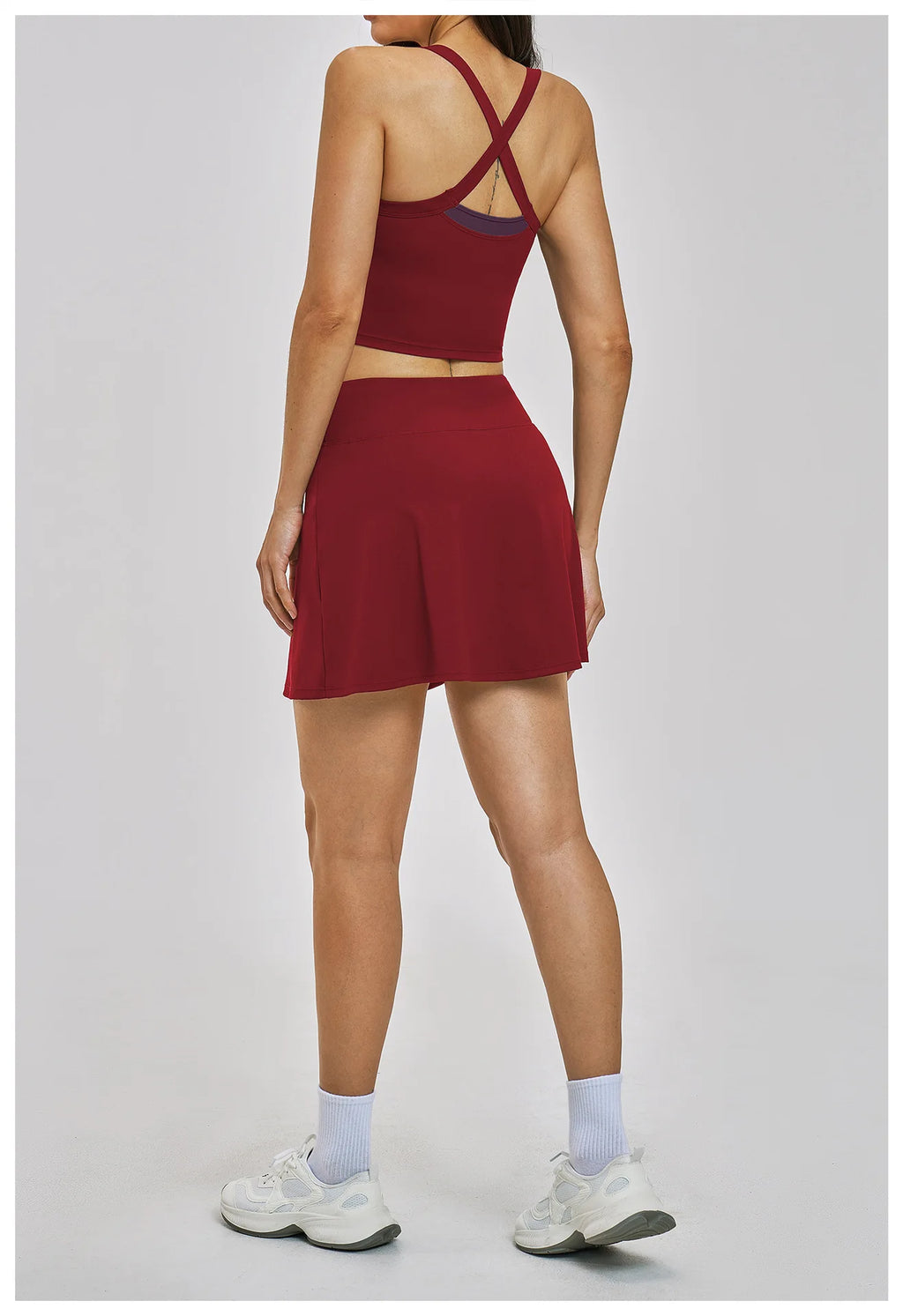 Person wearing a red athletic outfit on a light gray background