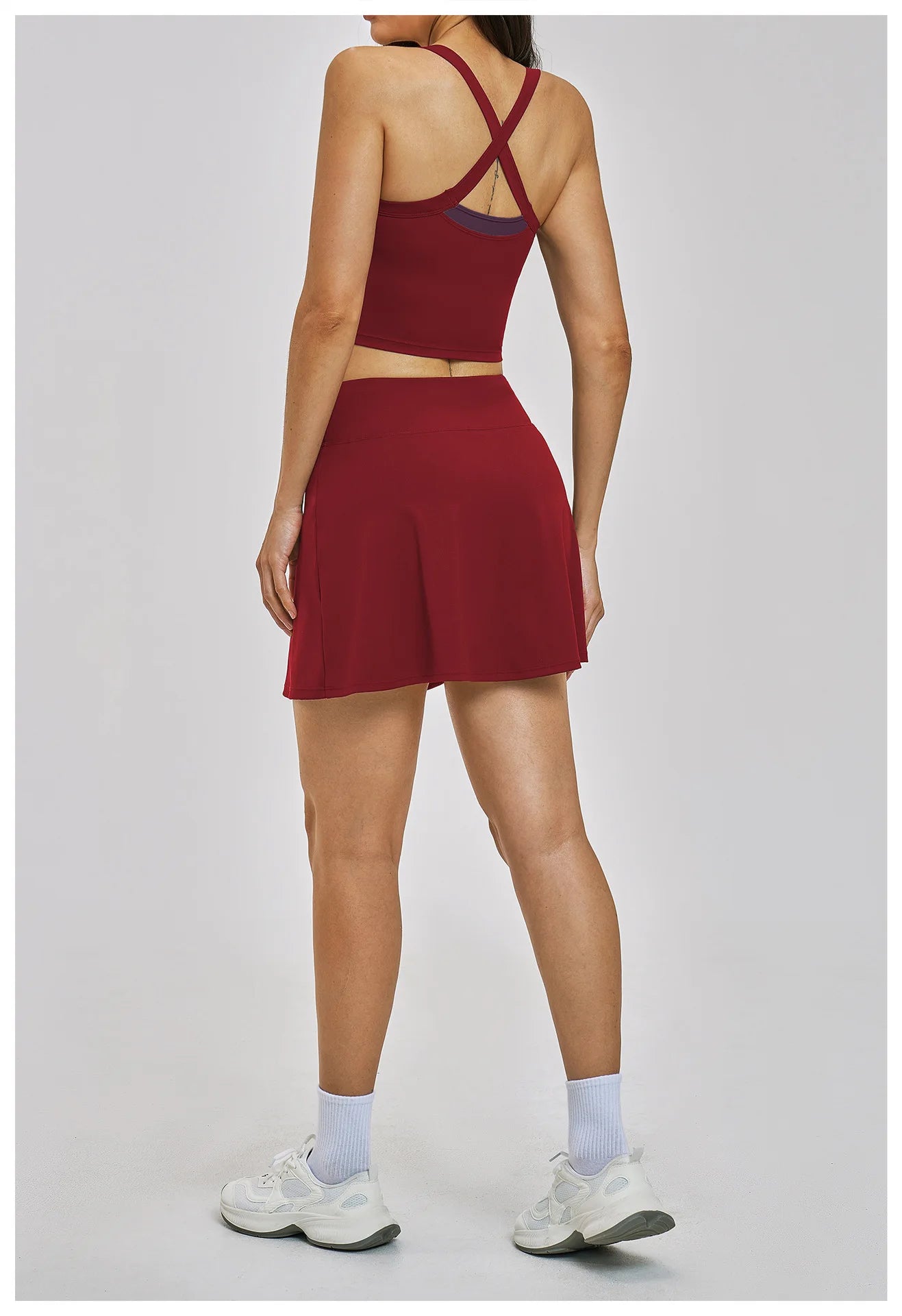 Person wearing a red athletic outfit on a light gray background