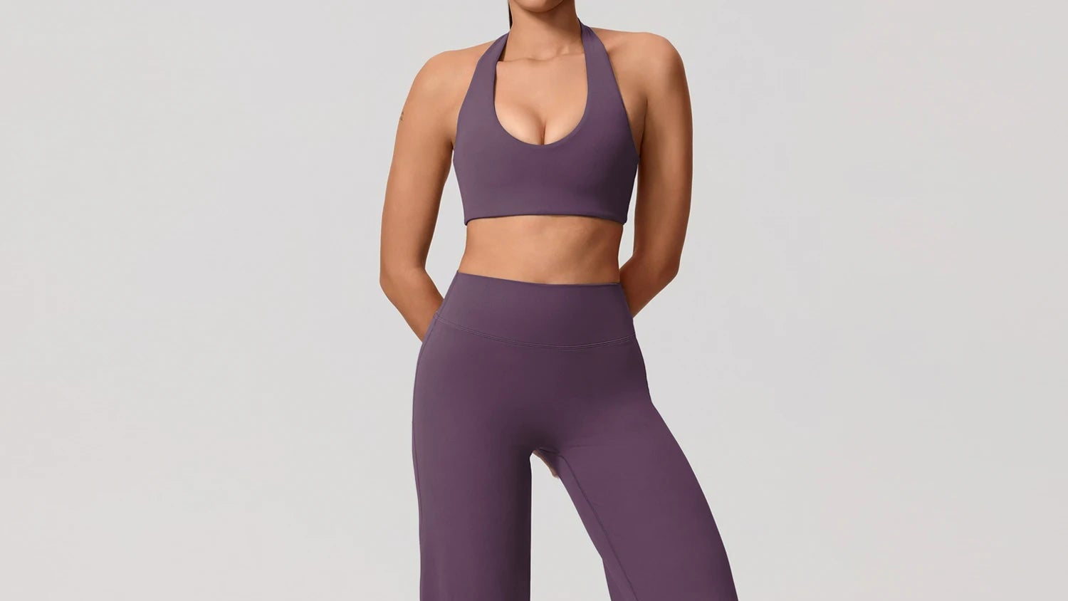 Person wearing a purple athletic outfit on a plain background