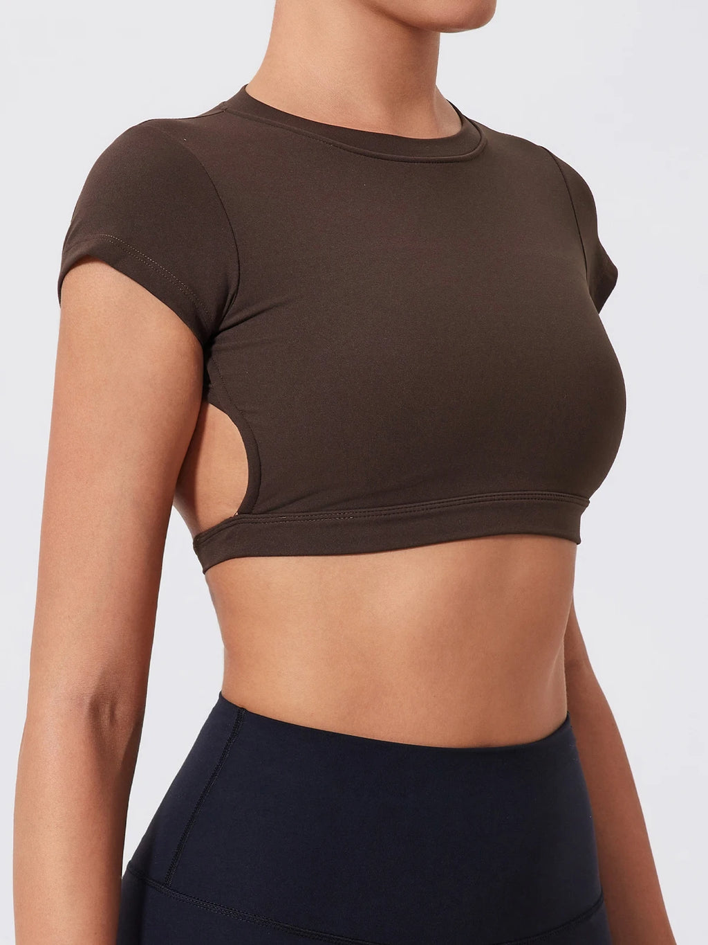 Brown crop top with cut-out design on a plain background