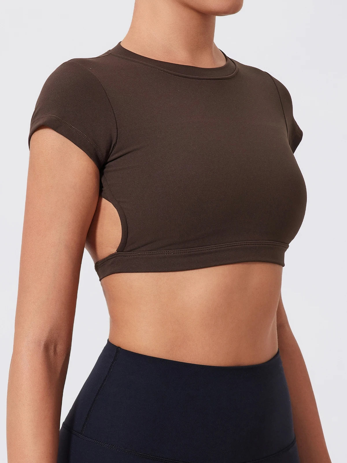 Brown crop top with cut-out design on a plain background