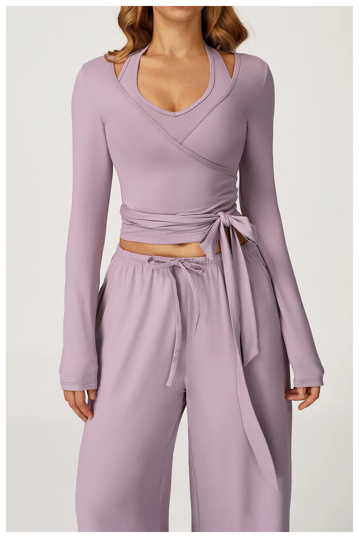 Purple long-sleeve top and wide-leg pants set on a white background