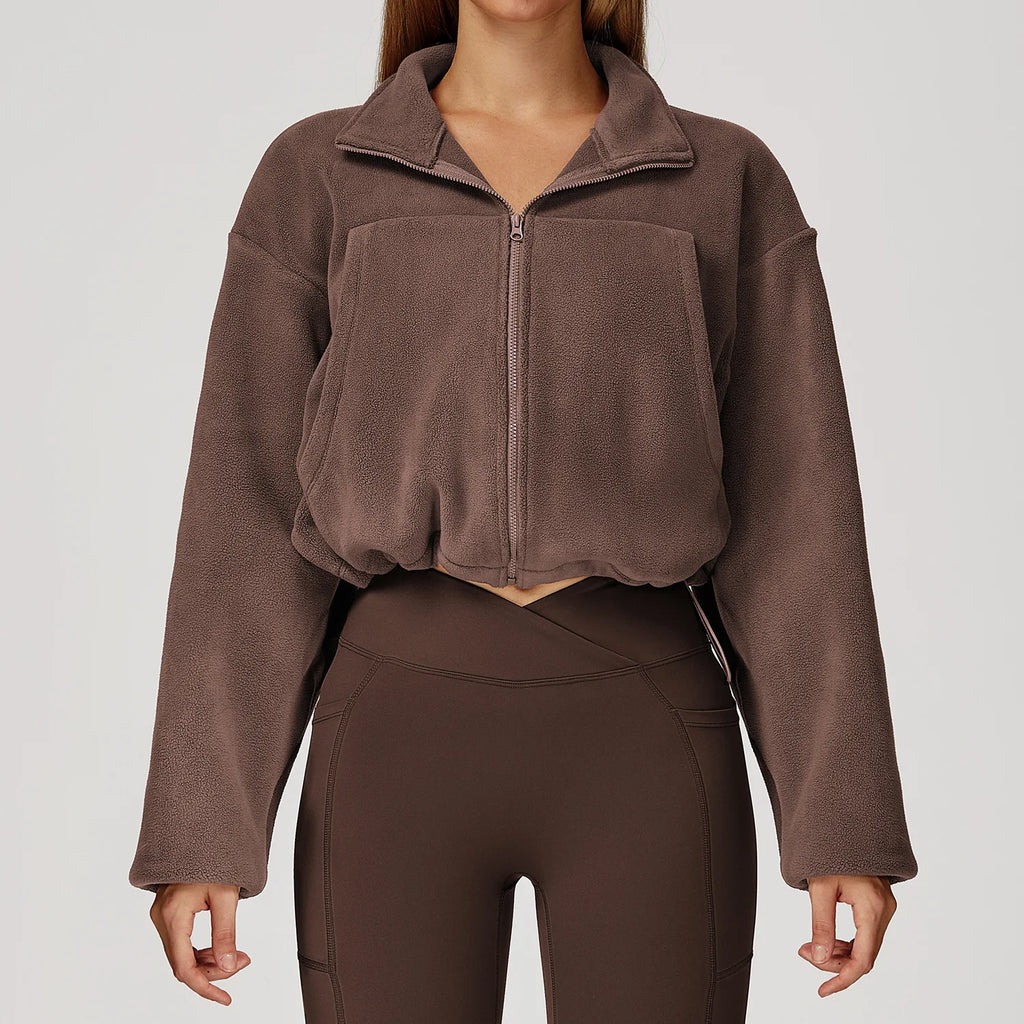 Brown fleece jacket and leggings on a plain background