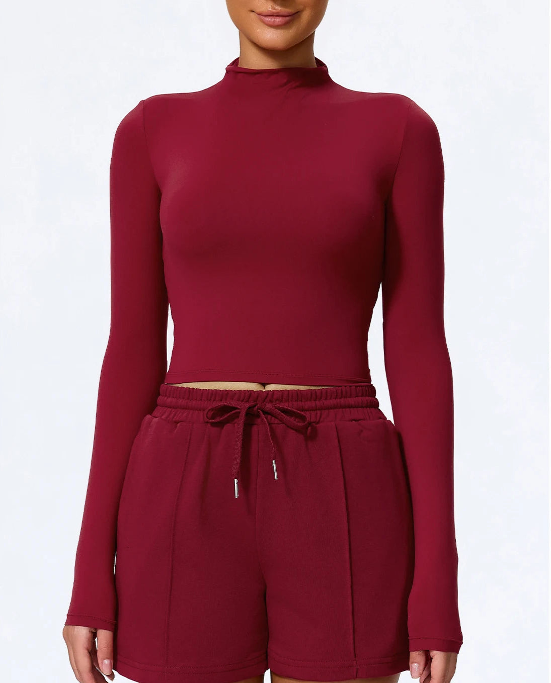 Maroon long-sleeve top and shorts set on a white background