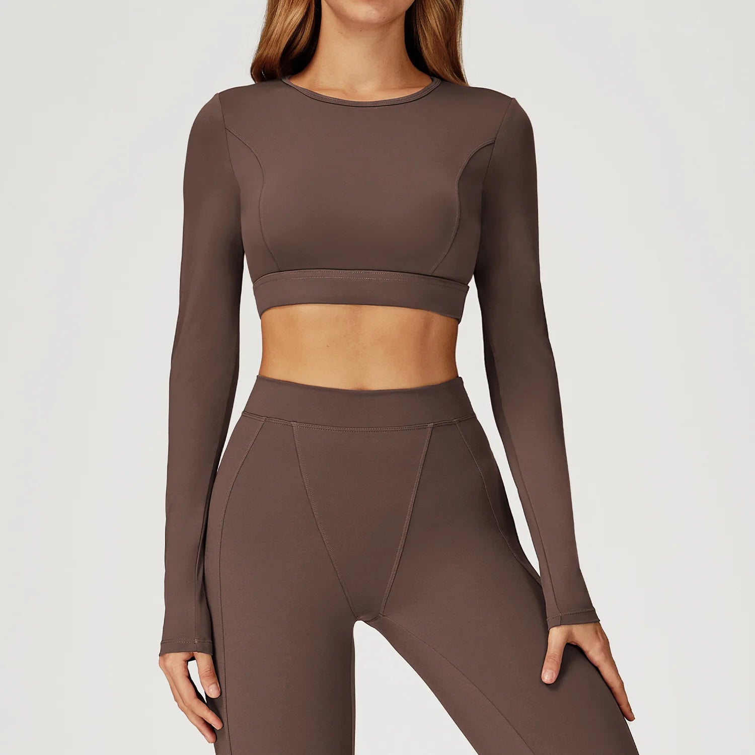 Brown long-sleeve athletic top and leggings on a plain background