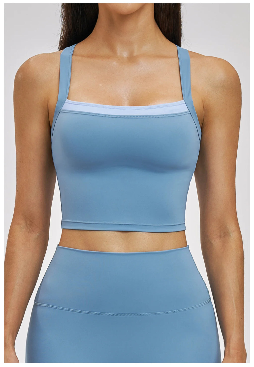 Blue athletic top worn by a person on a white background