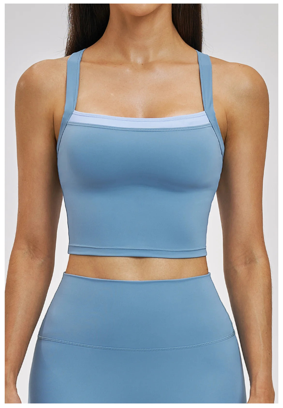 Blue athletic top worn by a person on a white background