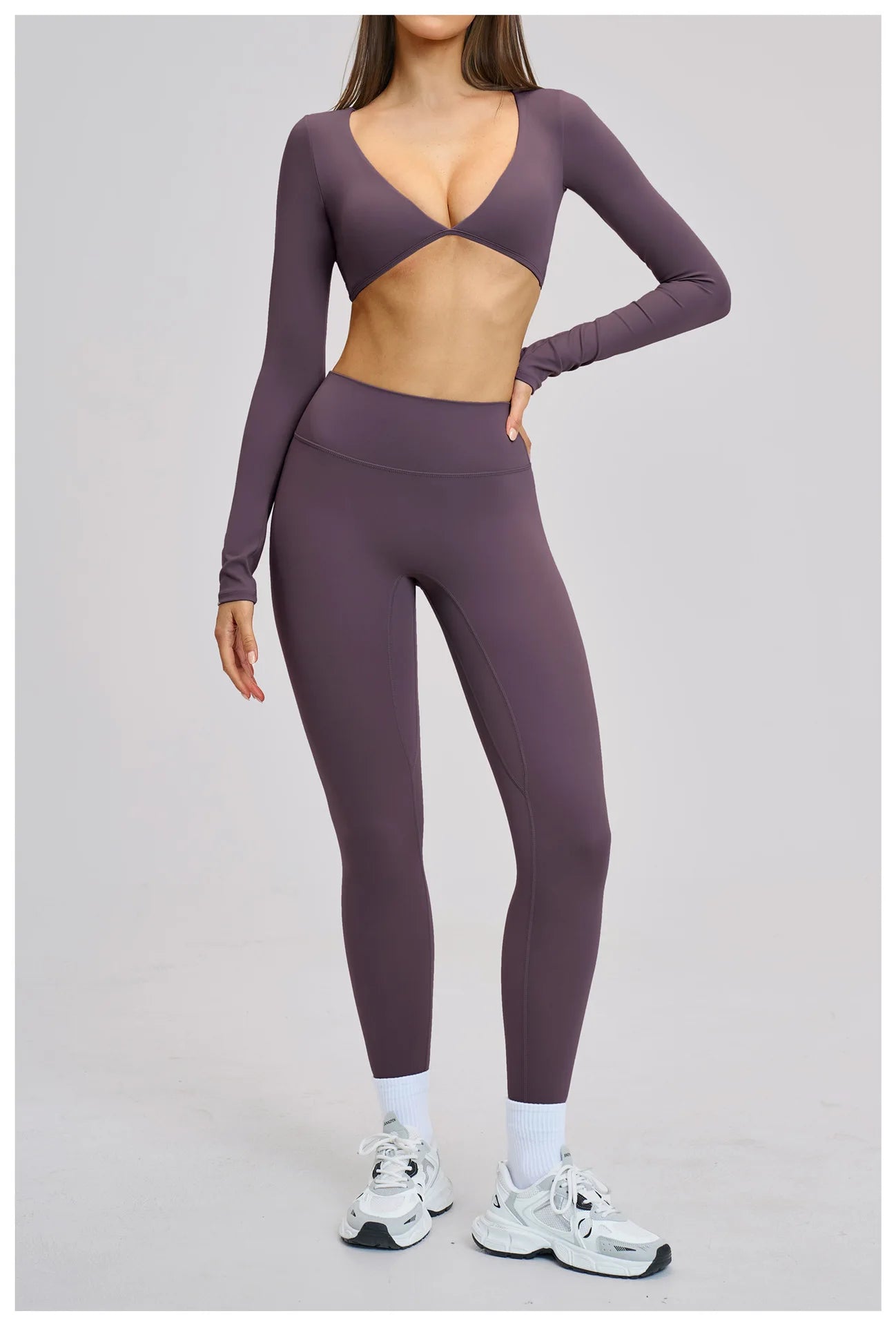 Person wearing a purple athletic outfit on a light gray background