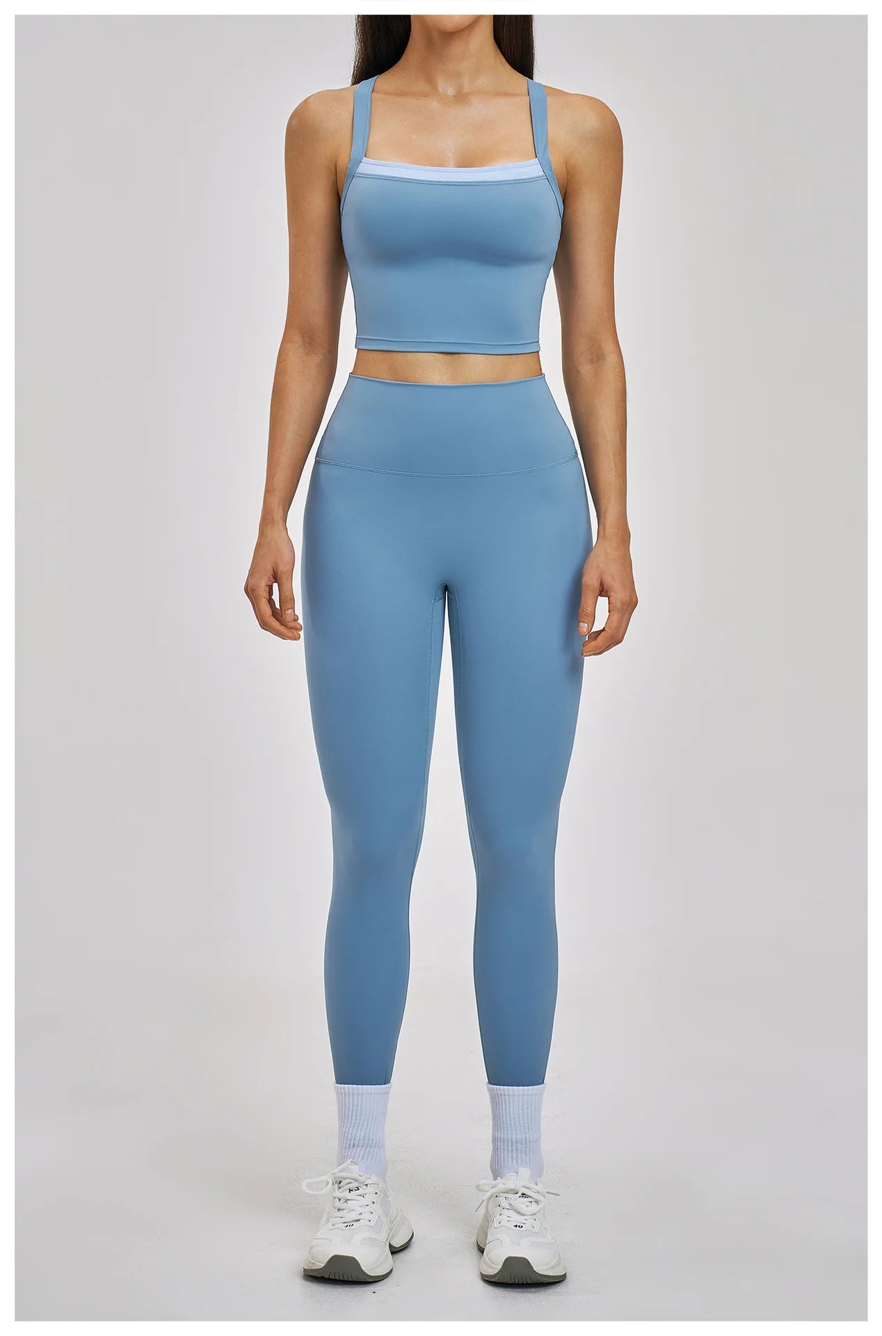 Person wearing a blue athletic outfit on a light gray background