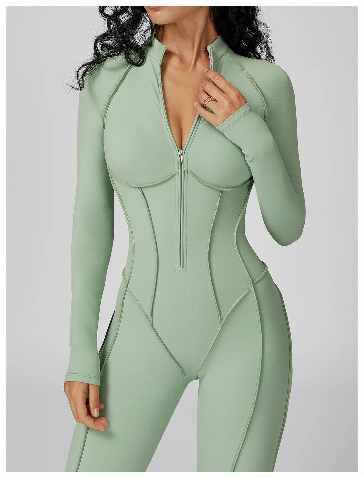 Mint green jumpsuit worn by a model on a light gray background