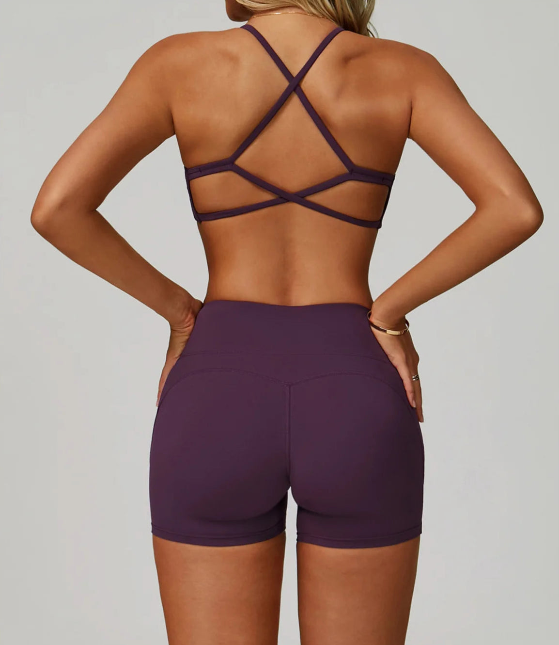 Purple sports bra and shorts set on a neutral background