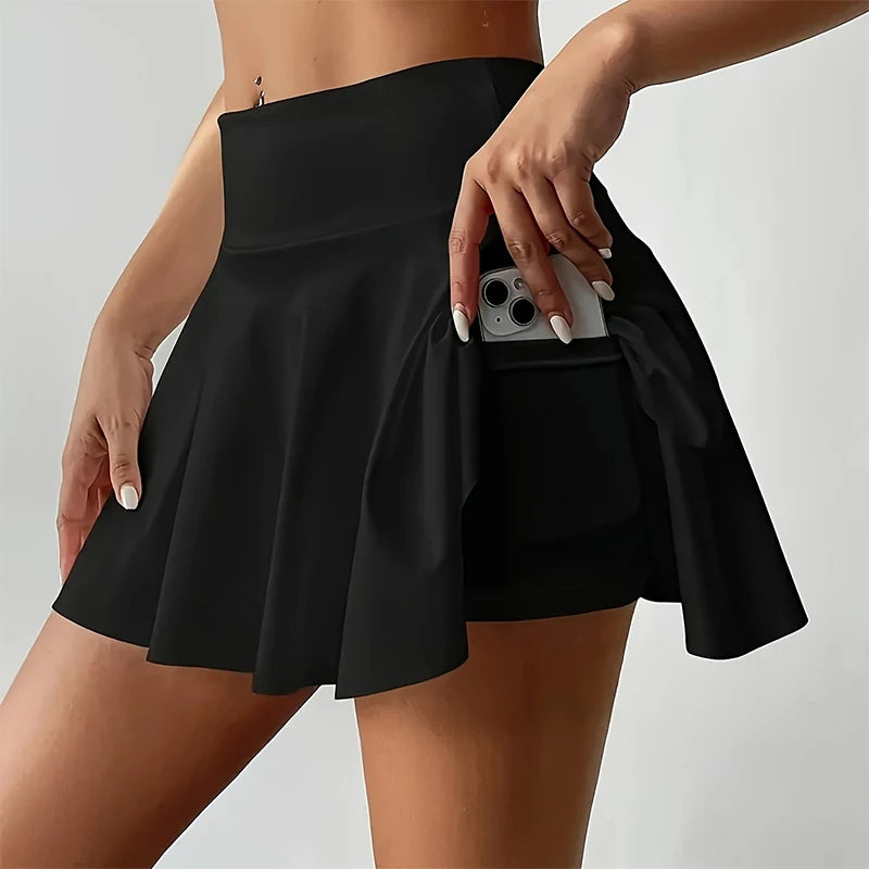 A high-waisted white sports mini skort with built-in safety shorts, suitable for tennis, yoga, golf, and casual wear.