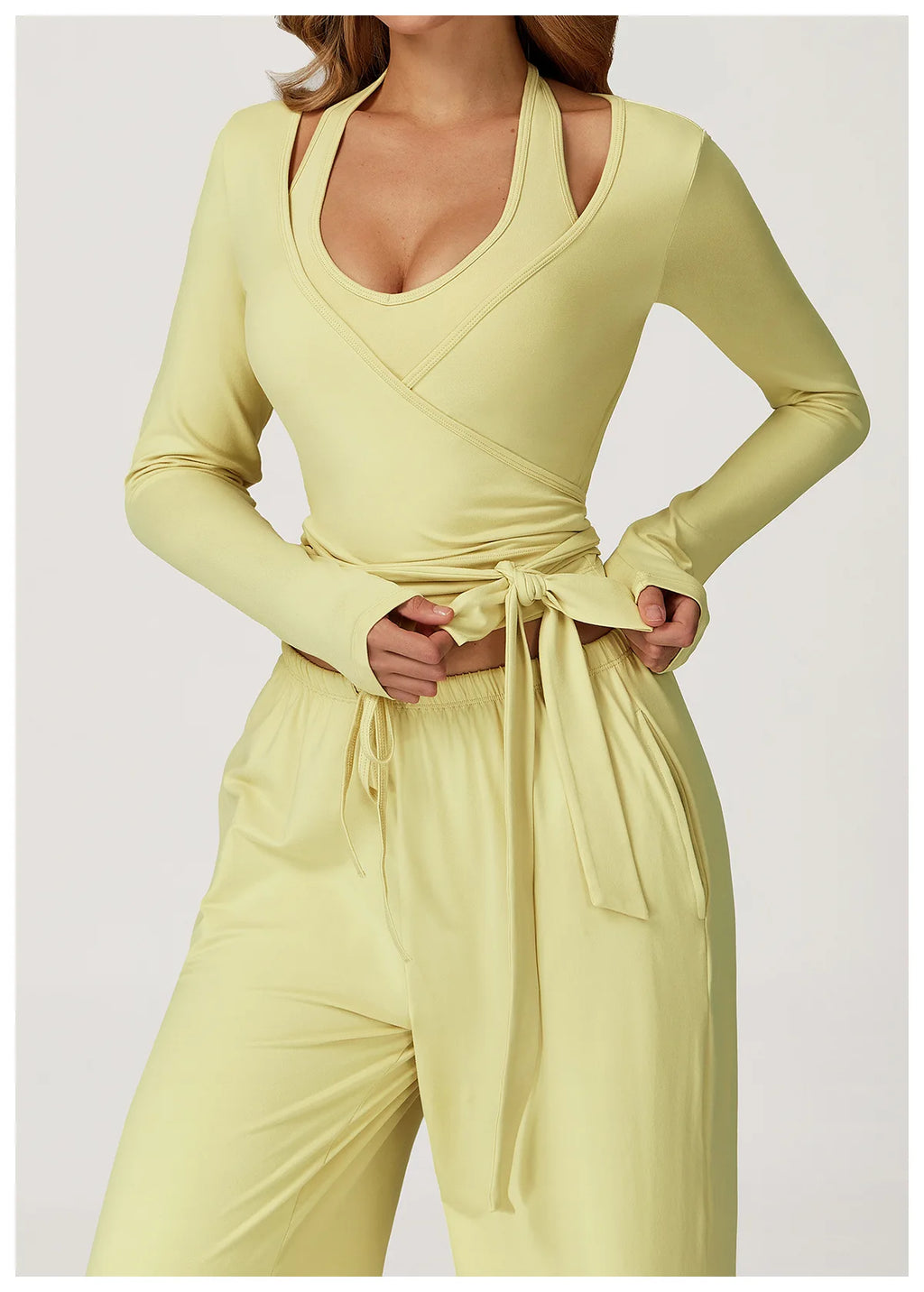Light yellow long-sleeve ballet wrap top and pants set on a white background
