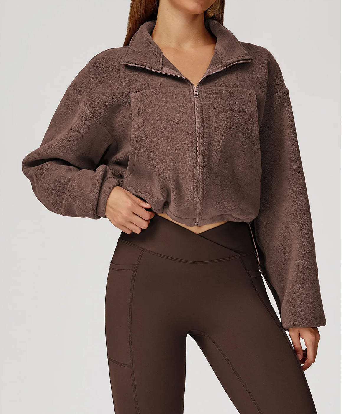 Brown cropped jacket and pants on a plain background
