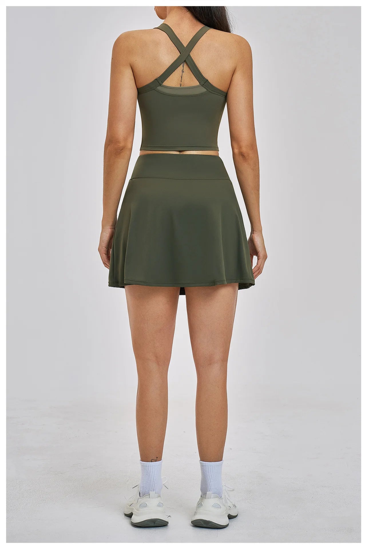 Person wearing a green athletic outfit on a gray background