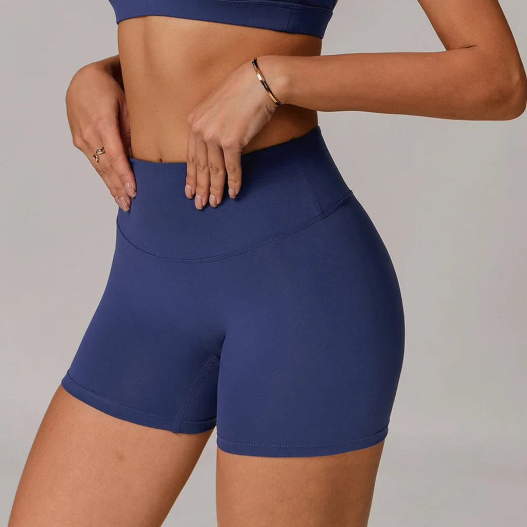 Person wearing blue athletic shorts on a plain background