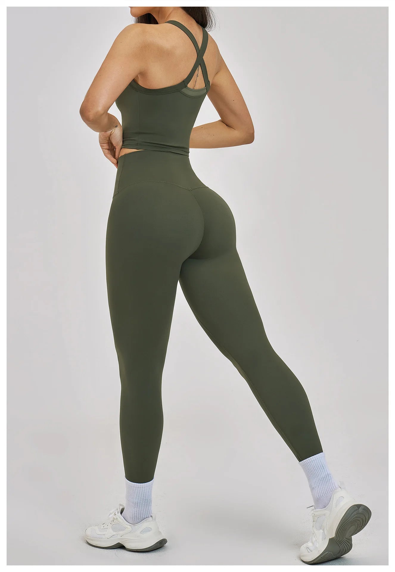 Person wearing a green athletic outfit on a light gray background