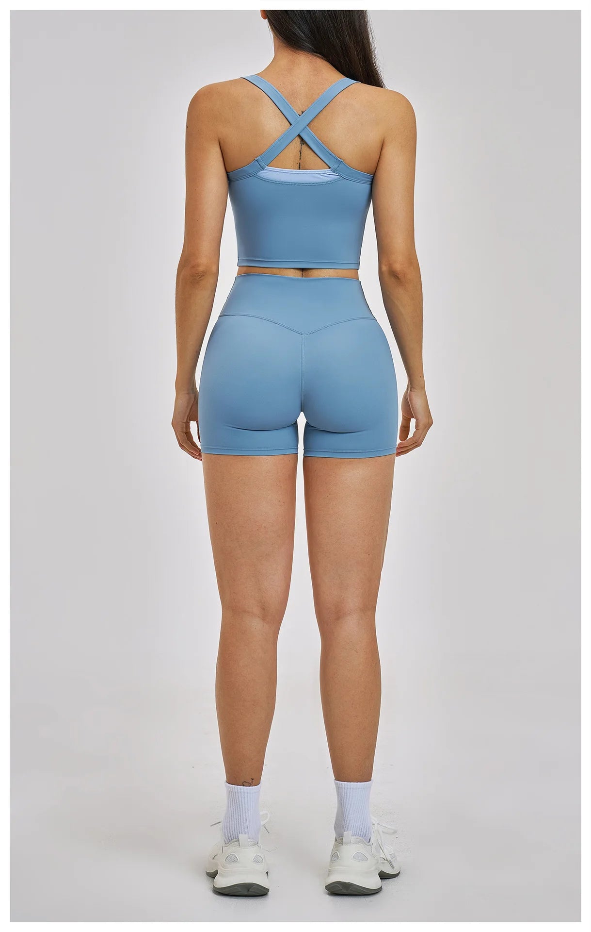 Person wearing a blue athletic outfit on a plain background